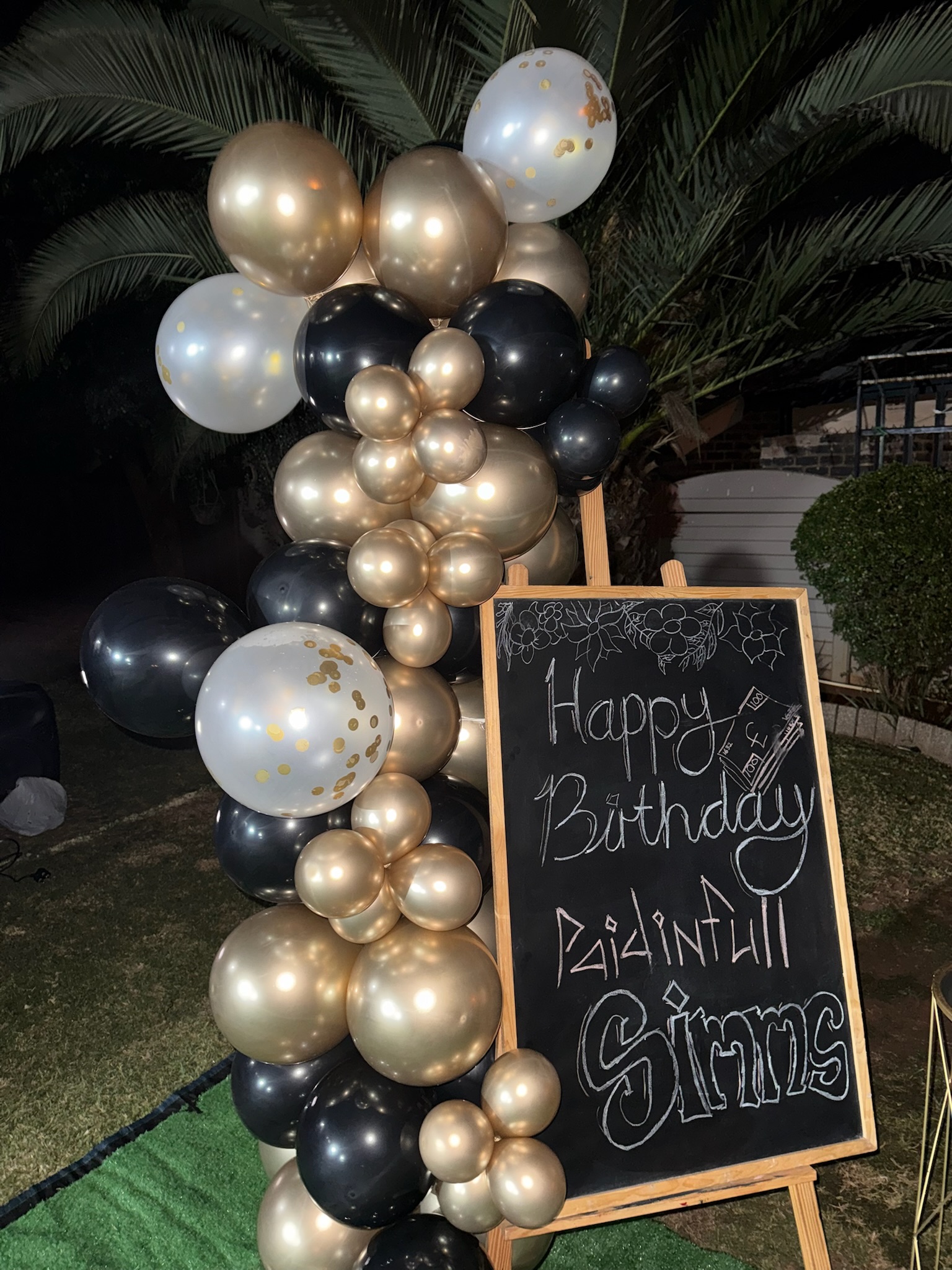 Decorative floral arrangements and balloon display at an Elora Events celebration